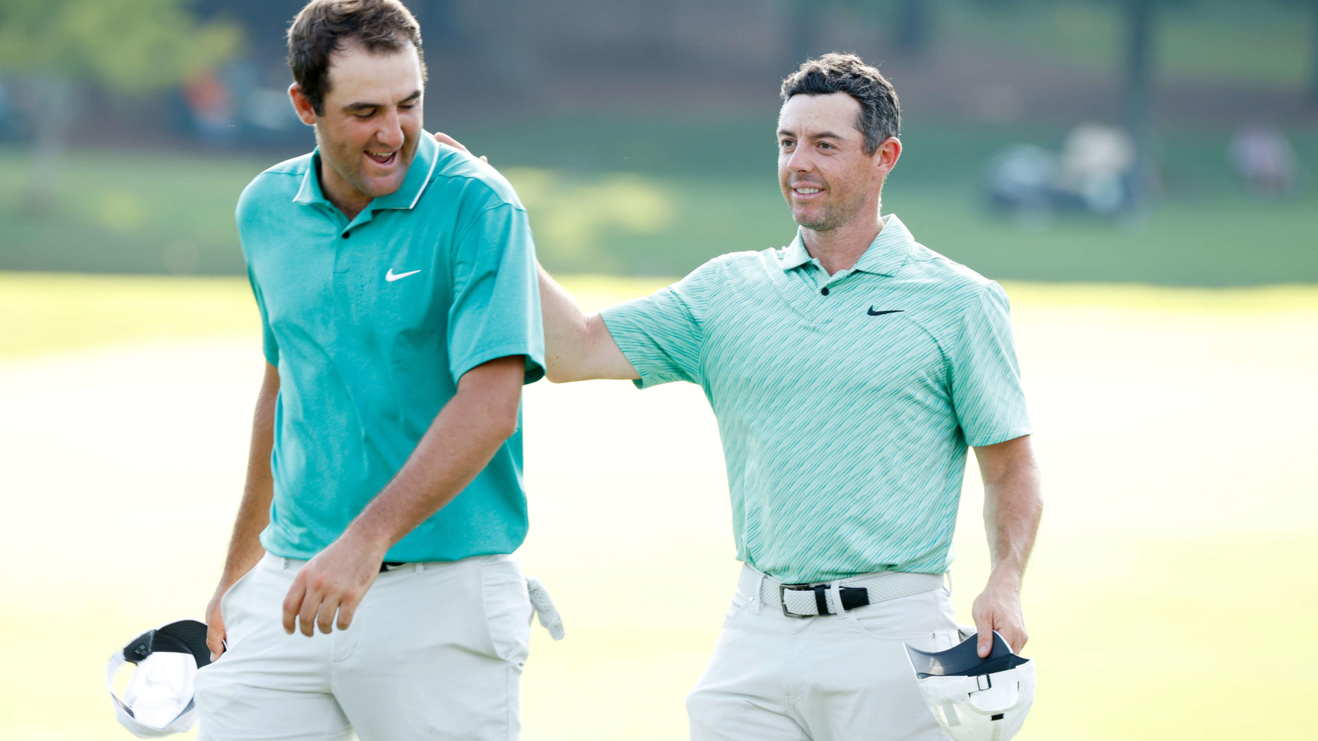 ATLANTA, GEORGIA - AUGUST 28: Scottie Scheffler of the United States congratulates Rory McIlroy of Northern Ireland on the 18th green after McIlroy won during the final round of the TOUR Championship at East Lake Golf Club on August 28, 2022 in Atlanta, Georgia. (Photo by Cliff Hawkins/Getty Images)