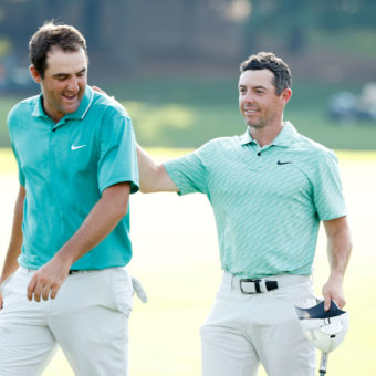 ATLANTA, GEORGIA - AUGUST 28: Scottie Scheffler of the United States congratulates Rory McIlroy of Northern Ireland on the 18th green after McIlroy won during the final round of the TOUR Championship at East Lake Golf Club on August 28, 2022 in Atlanta, Georgia. (Photo by Cliff Hawkins/Getty Images)