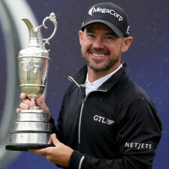 HOYLAKE, ENGLAND - JULY 23: Brian Harman of the United States poses for a photograph with the Claret Jug on the 18th green after winning The 151st Open on Day Four of The 151st Open at Royal Liverpool Golf Club on July 23, 2023 in Hoylake, England. (Photo by Warren Little/Getty Images)