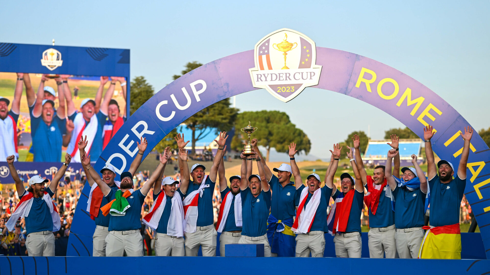 Team Europe captain Luke Donald, centre, lifts the cup with his team, from left, Tommy Fleetwood, Sepp Straka, Shane Lowry, Matt Fitzpatrick, Justin Rose, Tyrrell Hatton, Nicolai Højgaard, Rory McIlroy, Viktor Hovland, Ludvig Åberg, Robert MacIntyre and Jon Rahm during the singles matches on the final day of the 2023 Ryder Cup at Marco Simone Golf and Country Club in Rome, Italy. (Photo By Brendan Moran/Sportsfile via Getty Images)